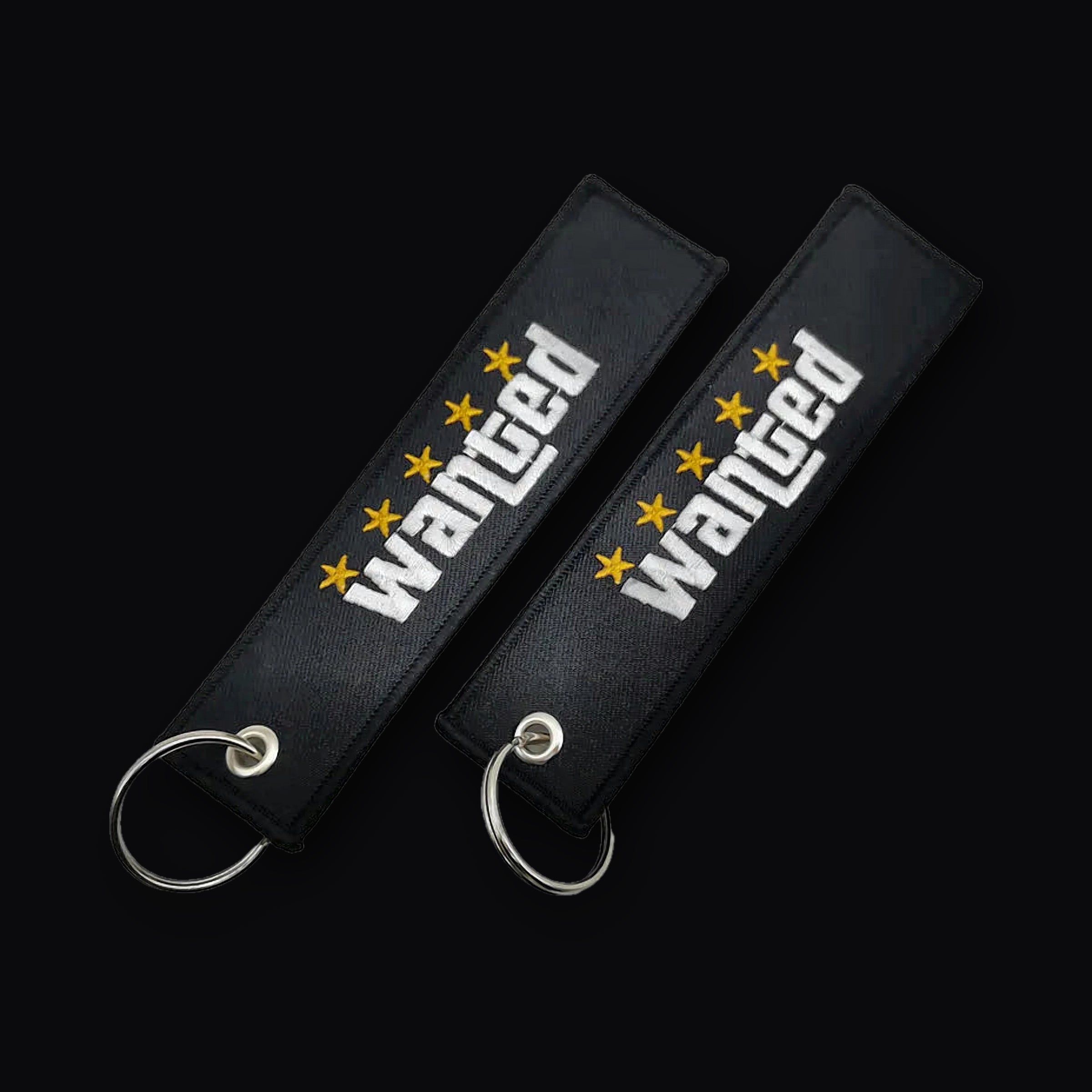 Two views of the Wanted Keytag showing both stitched sides