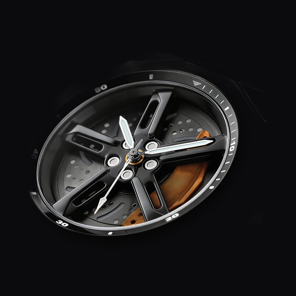 Close detail of the orange brake caliper on the Apex Chrono dial
